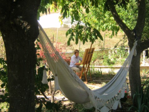 artist painting in garden